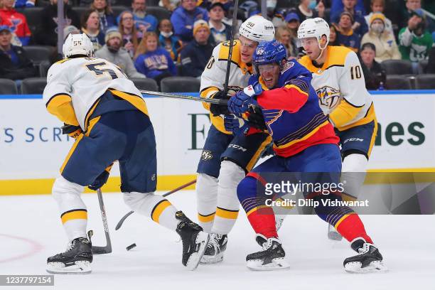 Mark Borowiecki of the Nashville Predators knocks David Perron of the St. Louis Blues off the puck during the first period at Enterprise Center on...