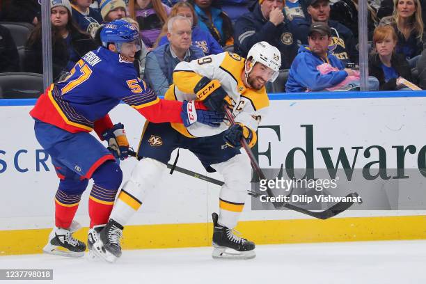 Roman Josi of the Nashville Predators passes the puck against David Perron of the St. Louis Blues during the second period at Enterprise Center on...