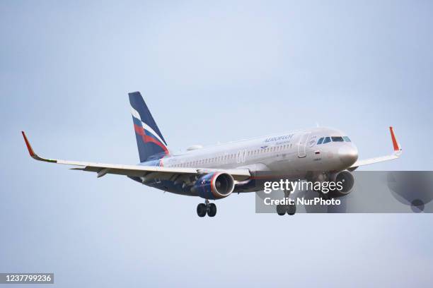 An Aeroflot - Russian Airlines Airbus A320 aircraft as seen on final approach flying and landing on the runway at Amsterdam Schiphol Airport with the...