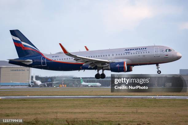 An Aeroflot - Russian Airlines Airbus A320 aircraft as seen on final approach flying and landing on the runway at Amsterdam Schiphol Airport with the...