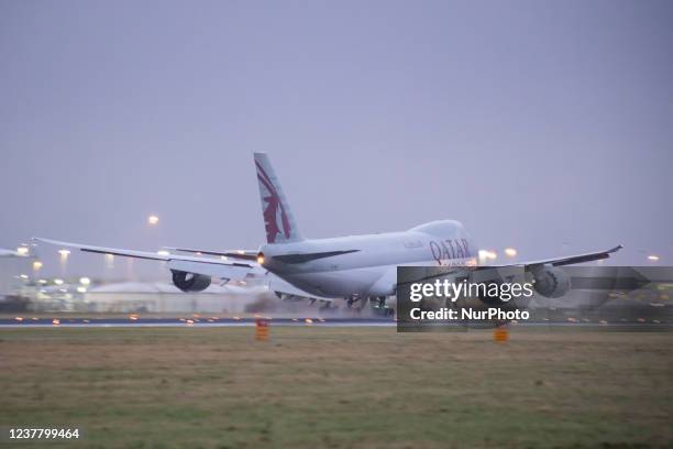 Qatar Airways Cargo Boeing 747-8F freight variant aircraft as seen landing at Amsterdam Schiphol Airport AMS EHAM in the evening. The quad jet Boeing...