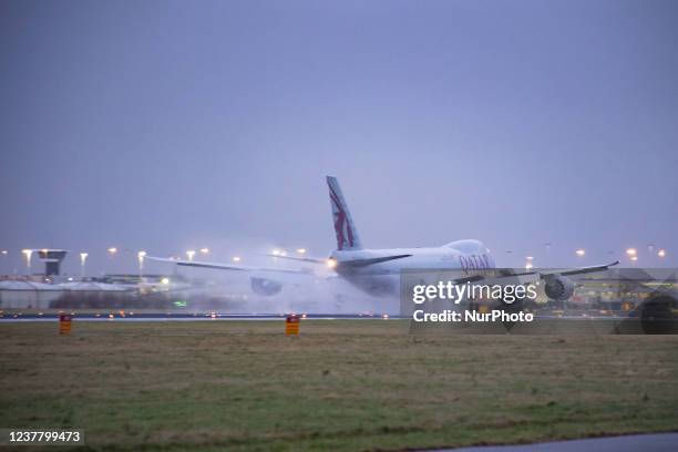 Qatar Airways Cargo Boeing 747-8F freight variant aircraft as seen landing at Amsterdam Schiphol Airport AMS EHAM in the evening. The quad jet Boeing...