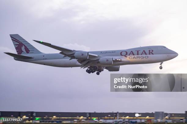 Qatar Airways Cargo Boeing 747-8F freight variant aircraft as seen landing at Amsterdam Schiphol Airport AMS EHAM in the evening. The quad jet Boeing...