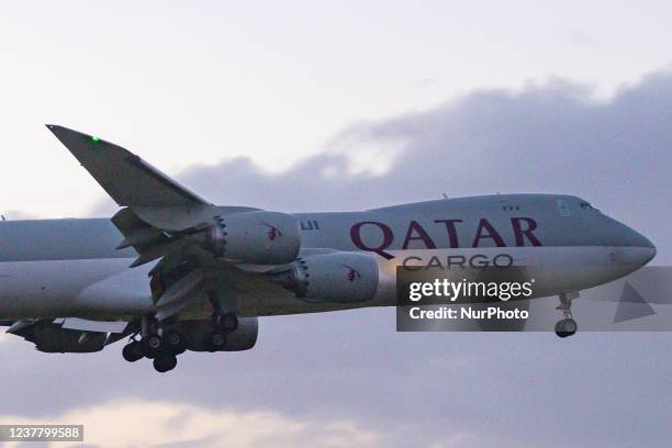 Qatar Airways Cargo Boeing 747-8F freight variant aircraft as seen landing at Amsterdam Schiphol Airport AMS EHAM in the evening. The quad jet Boeing...