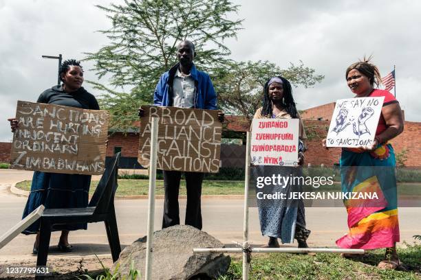 Members of the Broad Alliance Against Sanctions protest at the US Embassy in Harare on December 20, 2021 with banners calling for the lifting of...
