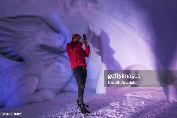 People enjoy ice sculptures at the complex where the biggest snow maze in the world is located in Zakopane, Poland, January 17, 2022. The snow maze...