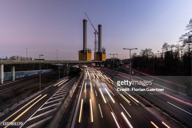 Stop-and-go traffic is pictured during blue hour in front of the combined heat and power station on January 17, 2022 in Berlin, Germany.
