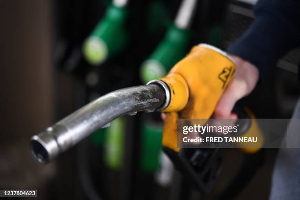 Driver fills his car tank at a petrol station in Ploneis, western France, on January 18 as oil prices are at their highest since 2014.