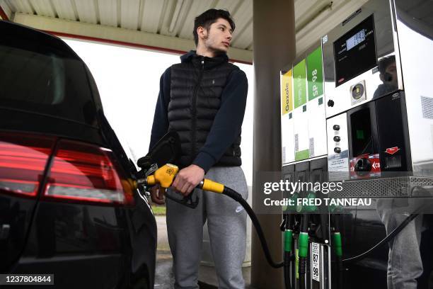 Driver fills his car tank at a petrol station in Ploneis, western France, on January 18 as oil prices are at their highest since 2014.