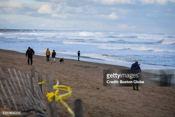 Salisbury People walk along the beach near the aftermath in Salisbury, MA on Jan. 17, 2022. A seaside motel and four residential buildings in...