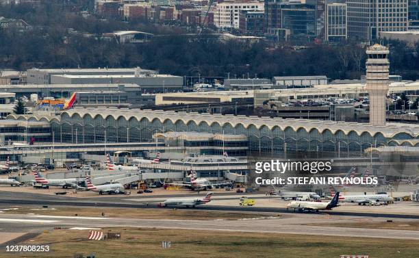 American Airlines and American Eagle planes sit at Ronald Reagan Washington National Airport in Arlington, Virginia on January 18 as seen from...