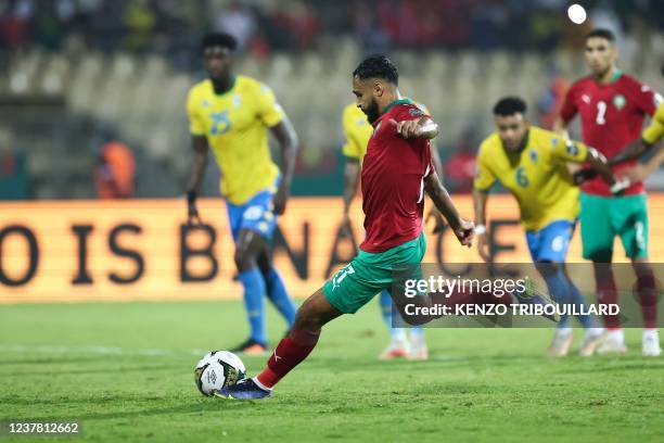 Morocco's forward Sofiane Boufal shoots and scores a penalty kick during the Group C Africa Cup of Nations 2021 football match between Gabon and...