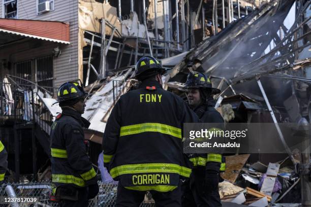Firefighters work on raw houses affected by 2 alarm fire and possible gas explosion in the Bronx in New York on January 18, 2022. One person has died...