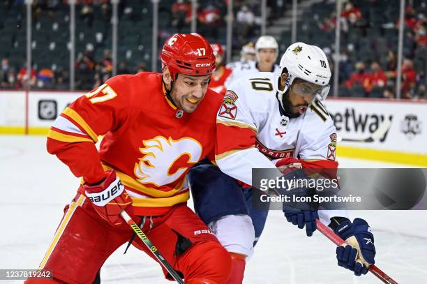 Calgary Flames Left Wing Milan Lucic and Florida Panthers Right Wing Anthony Duclair compete for the puck during the first period of an NHL game...