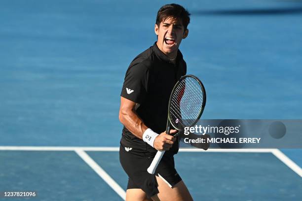 Chile's Christian Garin reacts as he plays Spain's Pedro Martinez during their men's singles match on day three of the Australian Open tennis...