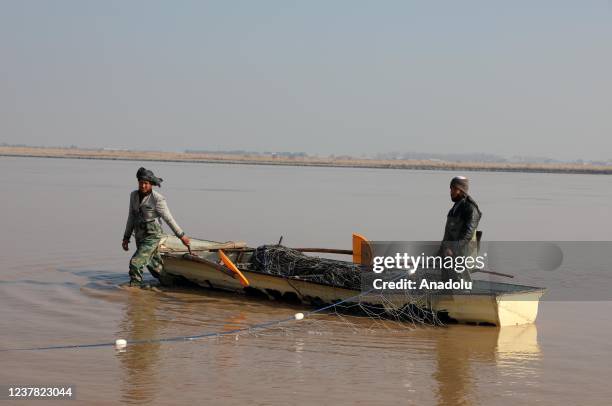 Turkmens living in Kunduz, Balkh and Juzcan provinces, catch fish to earn money in Amu Darya River in Balkh, Afghanistan on January 08, 2022.