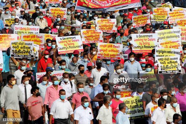 Sri Lankan supporters of the opposition People's Liberation Front shout slogans during a protest against the agreement with India to develop the...