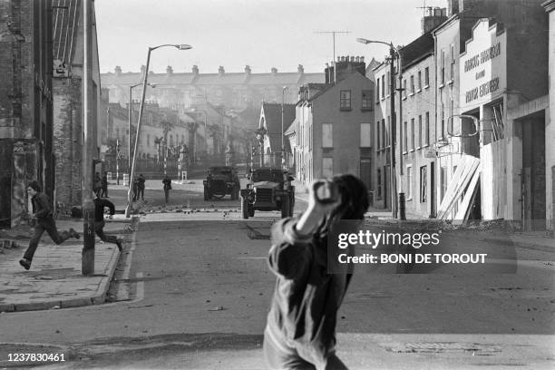 Young Catholic rioters hurl projectiles 02 March 1972 in Londonderry at British soldiers during a rally protesting the 30 January "Bloody Sunday"...