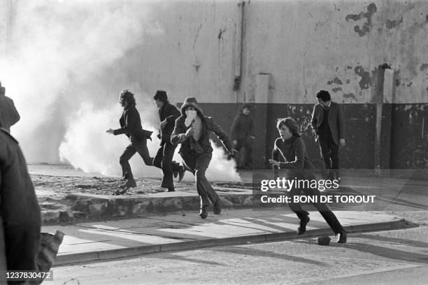 Young Catholic rioters hurl projectiles 02 March 1972 in Londonderry at British soldiers during a rally protesting the 30 January "Bloody Sunday"...