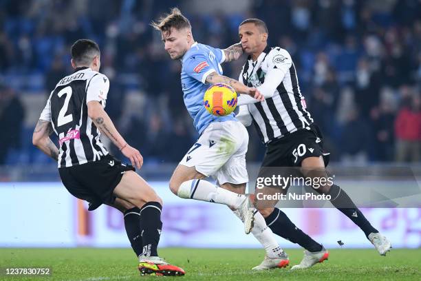 Ciro Immobile of SS Lazio is challenged by Nehuen Perez of Udinese Calcio and Rodrigo Becao of Udinese Calcio during the Italian Cup match between SS...