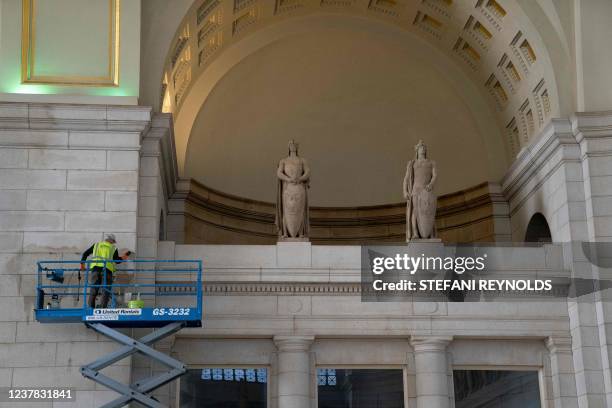 Worker cleans the walls of Union Station in Washington, DC, on January 19, 2022.