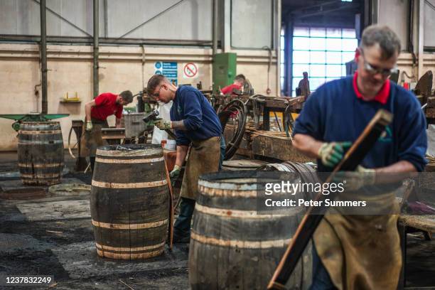 Coopers are seen making whisky casks at Speyside Cooperage on January 19, 2022 in Craigellachie, Scotland. Scotch whisky producers are still...