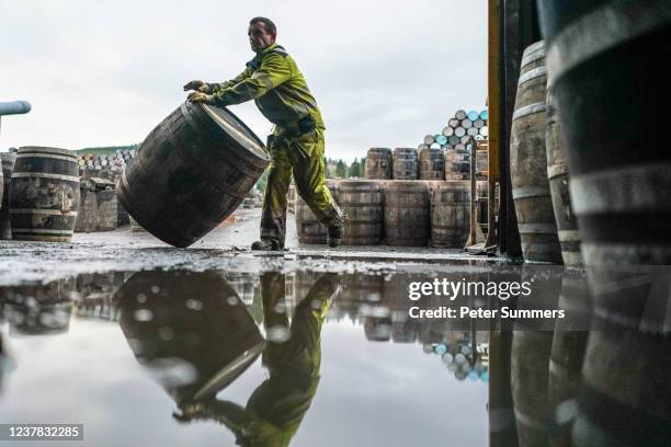 Worker is seen rolling a whisky cask at Speyside Cooperage on January 19, 2022 in Craigellachie, Scotland. Scotch whisky producers are still...