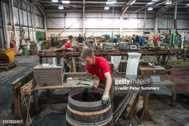 Coopers are seen repairing whisky casks at Speyside Cooperage on January 19, 2022 in Craigellachie, Scotland. Scotch whisky producers are still...