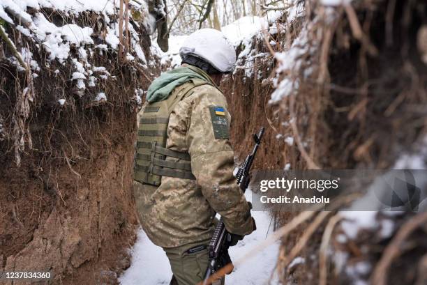 Ukrainian soldiers patrol the trenches along the frontline near the town of Zolote-4, Ukraine on January 19, 2022.