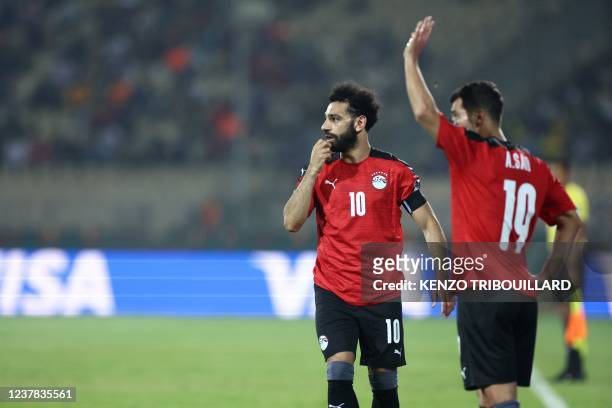 Egypt's forward Mohamed Salah and Egypt's midfielder Abdallah el Said react during the Group D Africa Cup of Nations 2021 football match between...