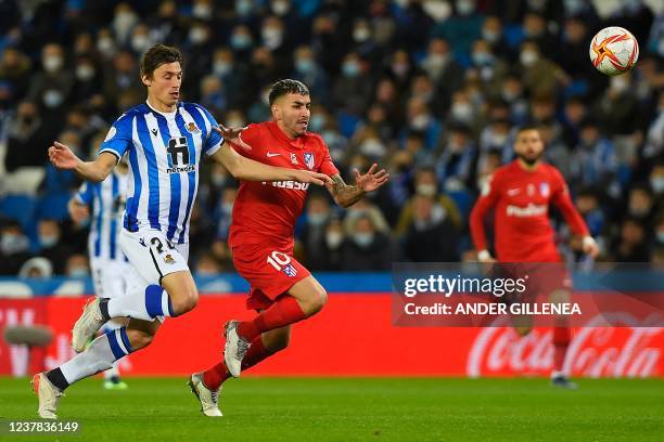 Atletico Madrid's Argentinian forward Angel Correa vies with Real Sociedad's French defender Robin Le Normand during the Copa del Rey round of 16...