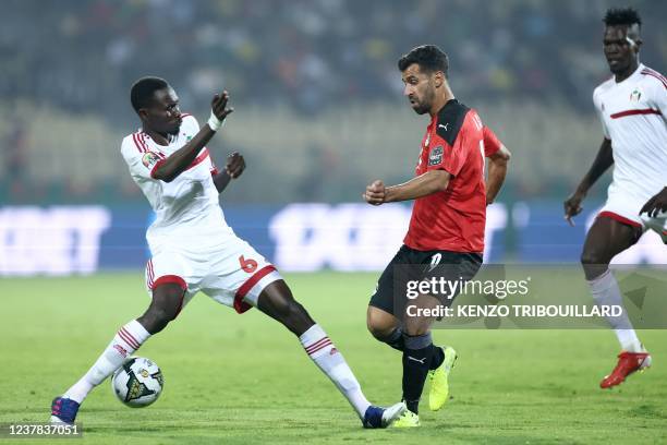 Egypt's midfielder Abdallah el Said challenges Sudan's defender Mustafa Karshom during the Group D Africa Cup of Nations 2021 football match between...