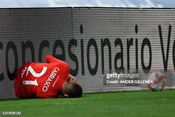 Atletico Madrid's Belgian midfielder Yannick Carrasco lies on the ground during the Copa del Rey round of 16 first leg football match between Real...