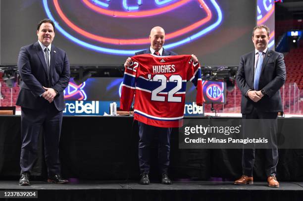 Newly appointed general manager of the Montreal Canadiens Kent Hughes , holds up a Canadiens' jersey along side executive vice president of hockey...