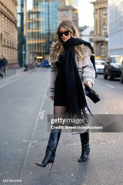 Influencer Paulina Kurka wearing a beige coat by Jacquemus, a black mini skirt by na-kd, a black pullover by Bershka, a black scarf by Zara,...