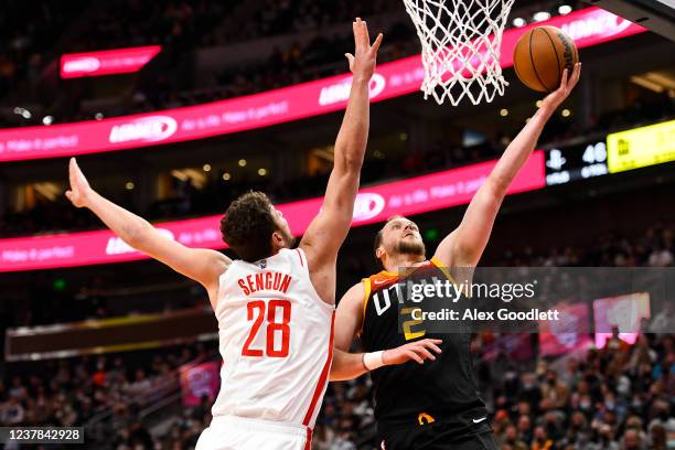 Joe Ingles of the Utah Jazz shoots over Alperen Sengun of the Houston Rockets during the first half of a game at Vivint Smart Home Arena on January...