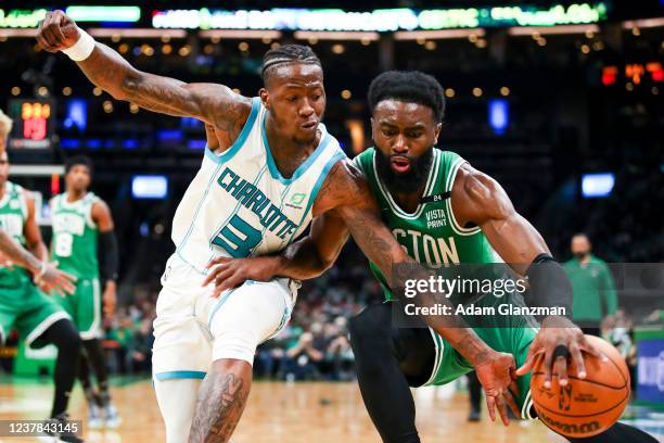 Jaylen Brown of the Boston Celtics is guarded by Terry Rozier of the Charlotte Hornets during a game at TD Garden on January 19, 2022 in Boston,...