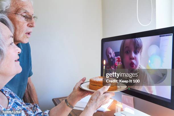 family celebrating a birthday together via video call - lockdown home stock pictures, royalty-free photos & images