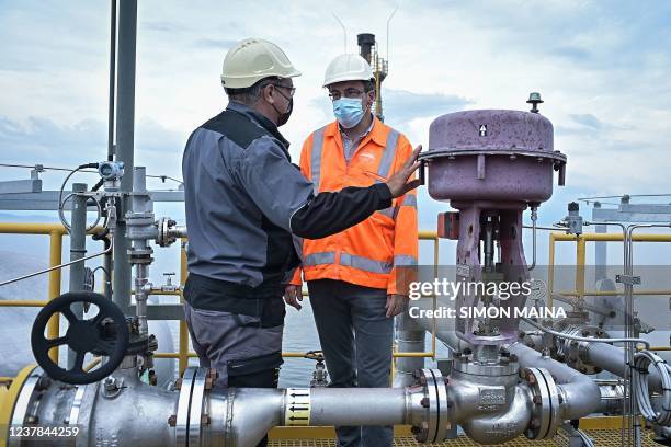 Francois Darchambeau- lake expert and senior enviriomental supervisor consults with David Krasner, gas production manager, ontop of the barge...