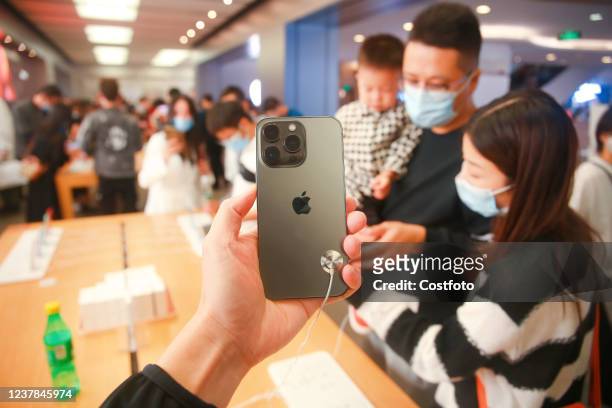 Customers look at the iPhone13 smartphone at apple's flagship store in Shanghai, China, on October 12, 2021. January 19, 2022 - Apple regained the...