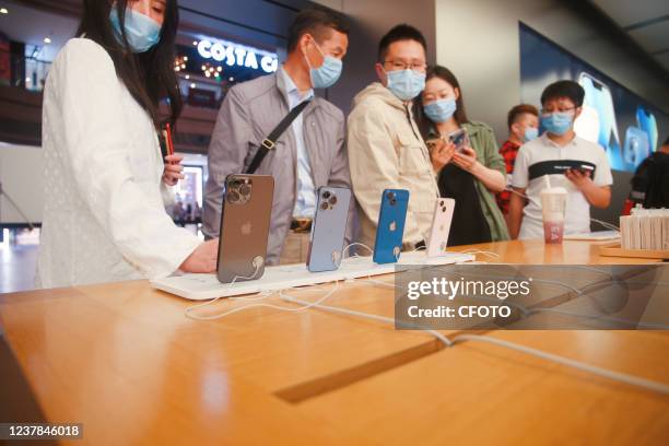 Customers look at the iPhone13 smartphone at apple's flagship store in Shanghai, China, on October 12, 2021. January 19, 2022 - Apple regained the...