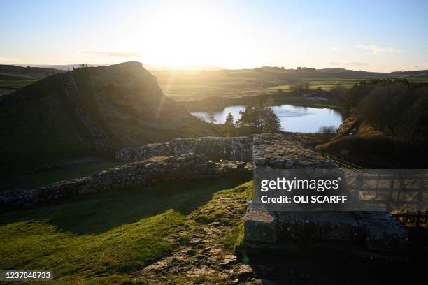 Picture shows a section of Hadrian's Wall at sunset above Cawfield Quarry near Hexham, northern England on January 19, 2022. This year marks the 1900...