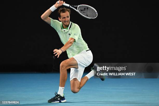 Russia's Daniil Medvedev hits a return against Australia's Nick Kyrgios during their men's singles match on day four of the Australian Open tennis...