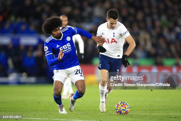 Hamza Choudhury of Leicester City battles with Sergio Reguilon of Tottenham Hotspur during the Premier League match between Leicester City and...