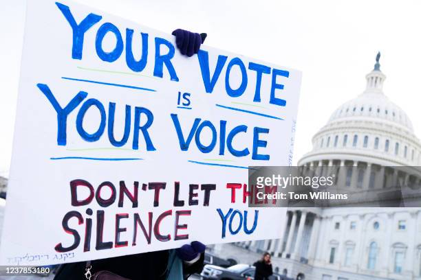 Demonstrator holds a sign at rally with Rep. Jamaal Bowman, D-N.Y., outside the U.S. Capitol to urge the Senate to pass voting rights legislation on...
