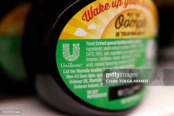 Unilever logo is picture on a jar of the company's Marmite yeast extact product, in a shop in London on January 20, 2022. - Consumer goods giant...