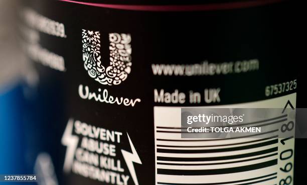 Unilever logo is picture on a bottle of the company's Sure deodorant product, in a shop in London on January 20, 2022. - Consumer goods giant...