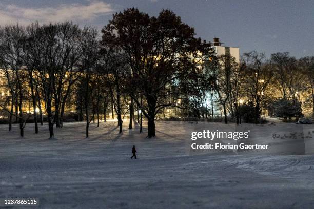 Walking person is pictured after snowfall on January 20, 2022 in Berlin, Germany.