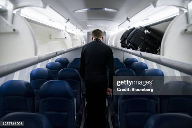 Flight attendant walks on board a Delta Air Lines plane at Raleigh-Durham International Airport in Morrisville, North Carolina, U.S., on Thursday,...