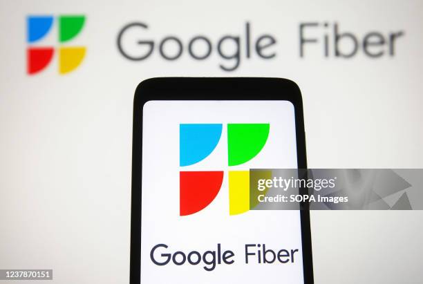 In this photo illustration, a Google Fiber Inc. Logo is seen displayed on a smartphone screen and in the background.